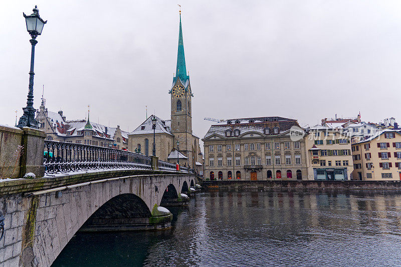 Beautiful cityscape of the old town of Zürich with protestant church Women's Minster, Minster Bridge and Limmat River in the foreground.